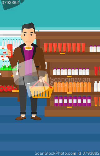 Image of Customer with shopping basket and tube of cream.