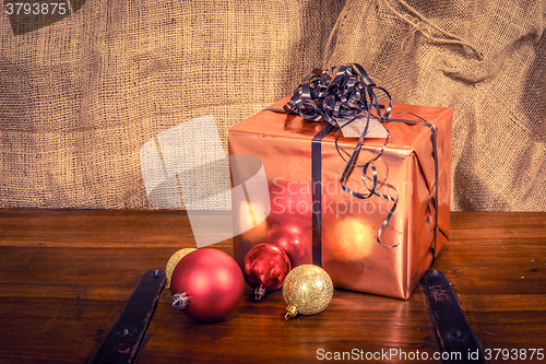 Image of Shiny Christmas gift on a wooden table