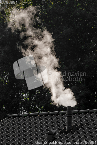 Image of Smoking chimney on a house