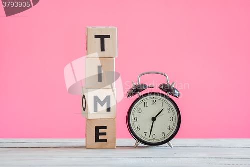 Image of Alarm clock and cubes spelling time