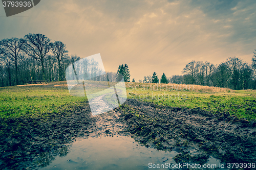 Image of Muddy road with a puddle