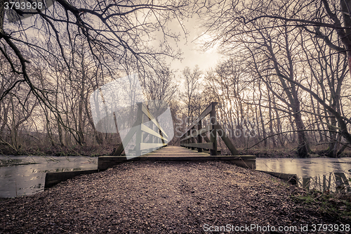 Image of Wooden bridge over a frozen lake