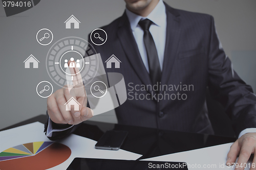 Image of businessman clicks on the icon lodge. search property. The virtual screen