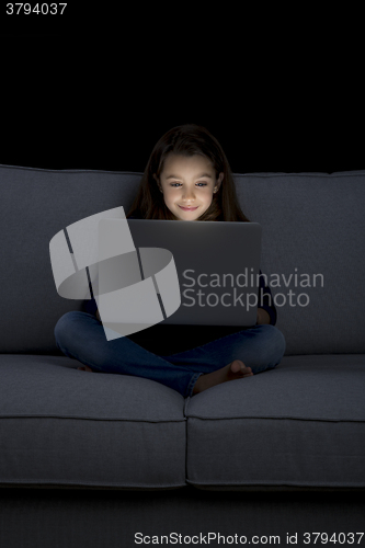 Image of Little girl working with a laptop