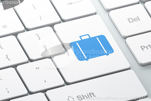 Image of Tourism concept: Bag on computer keyboard background