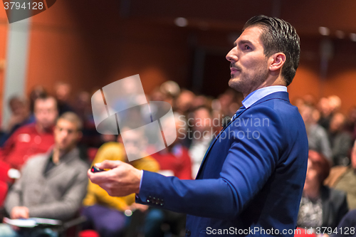 Image of Public speaker giving talk at Business Event.