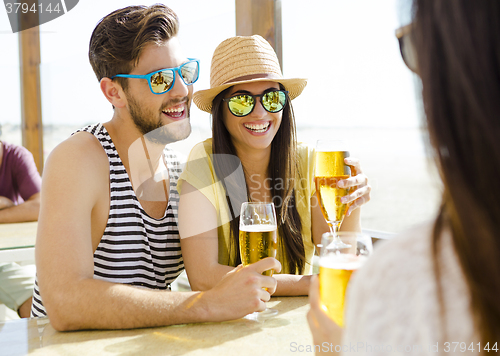 Image of Friends drinking a cold beer