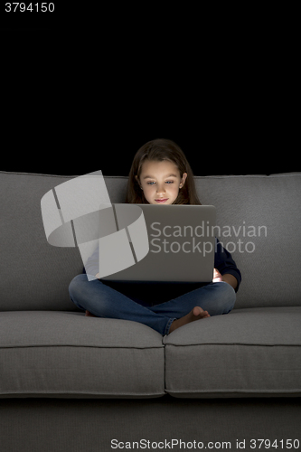 Image of Little girl working with a laptop