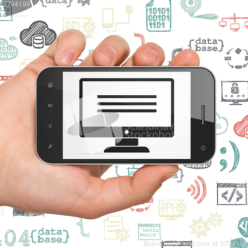 Image of Database concept: Hand Holding Smartphone with Monitor on display