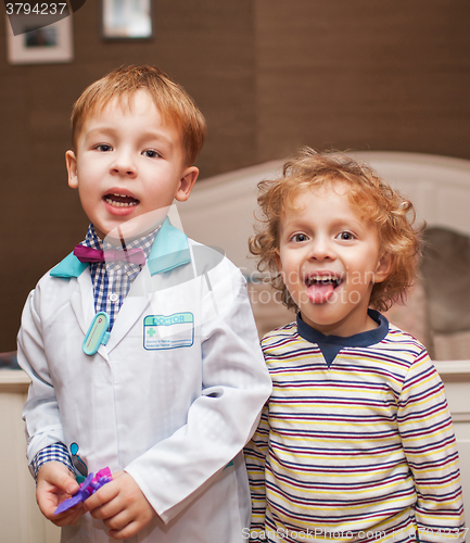 Image of Little doctor and his patient showing tongue