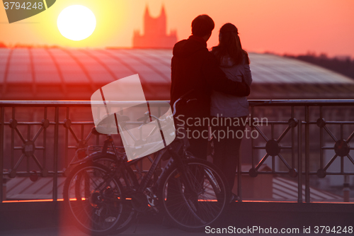 Image of Couple enjoying scenic sunset in the city