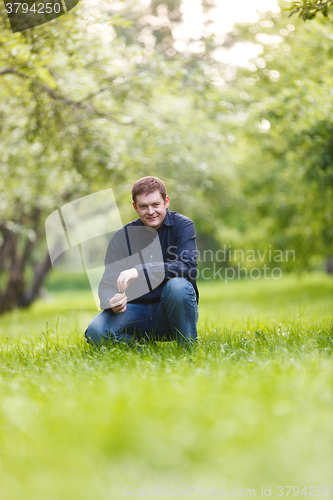 Image of Middle-aged man resting in the city park