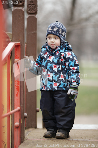 Image of Cute little boy dressed in trendy winter clothes