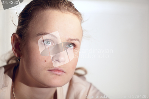 Image of Young woman is watching an interesting film on tv.