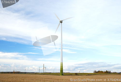 Image of Wind turbine with motion blured blades.