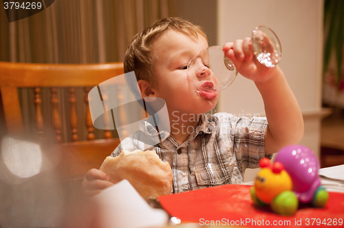 Image of Young boy enjoying lunch