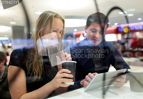 Image of Man and woman during coffee break with pad