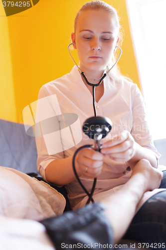 Image of Nurse with stethoscope - blood pressure