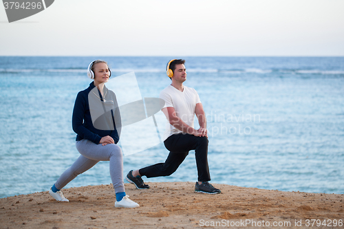 Image of Young people listening to music and exercising outdoor