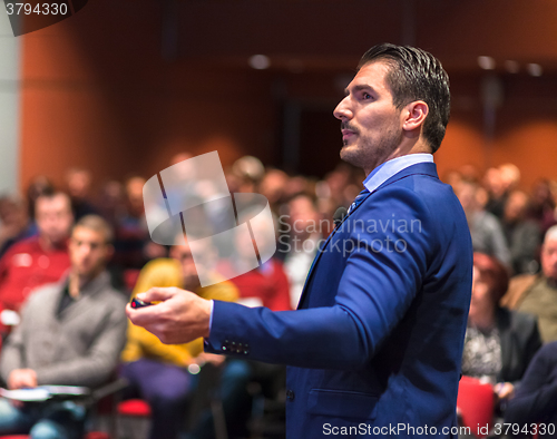 Image of Public speaker giving talk at Business Event.