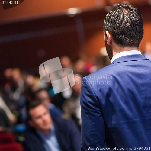 Image of Public speaker giving talk at Business Event.