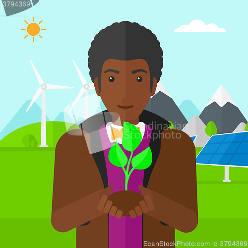 Image of Man holding plant.