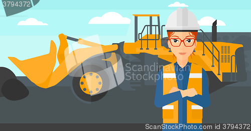 Image of Miner with mining equipment on background.