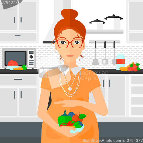 Image of Pregnant woman with vegetables.