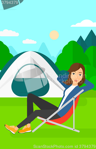 Image of Woman sitting in folding chair.