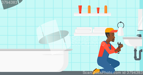 Image of Man repairing sink.