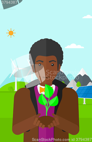 Image of Man holding plant.