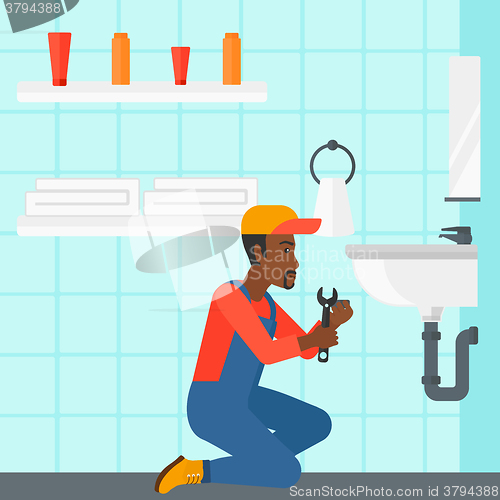 Image of Man repairing sink.