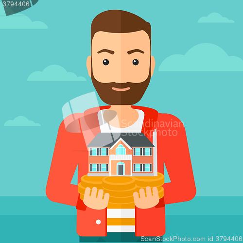 Image of Man holding house model.