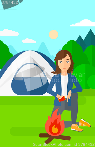 Image of Woman kindling fire.