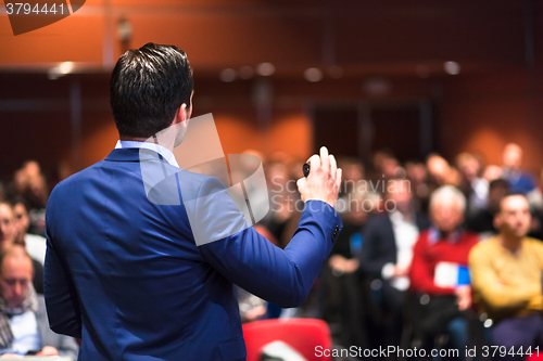 Image of Public speaker giving talk at Business Event.