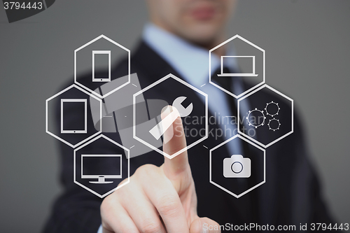 Image of technology, internet and networking concept - businessman pressing technical support button on virtual screens