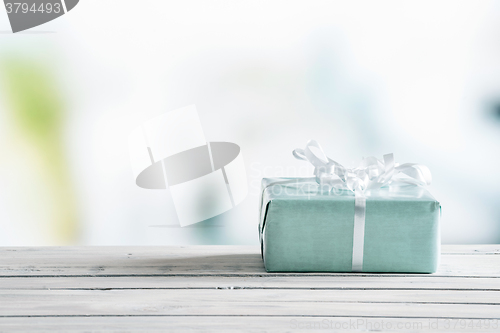 Image of Blue gift box on a wooden table