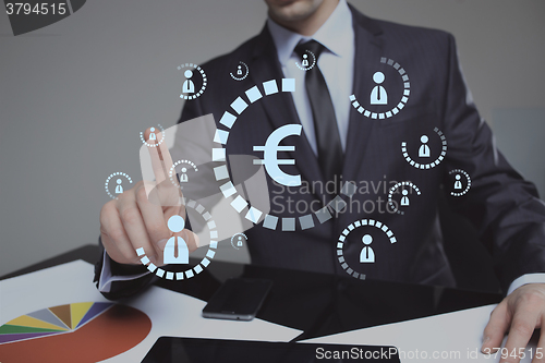 Image of Businessman pushing virtual button eur