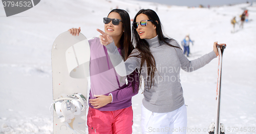 Image of Two stylish women with their snowboards