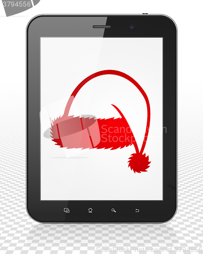 Image of Holiday concept: Tablet Pc Computer with Christmas Hat on display