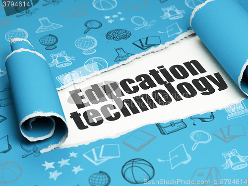 Image of Studying concept: black text Education Technology under the piece of  torn paper