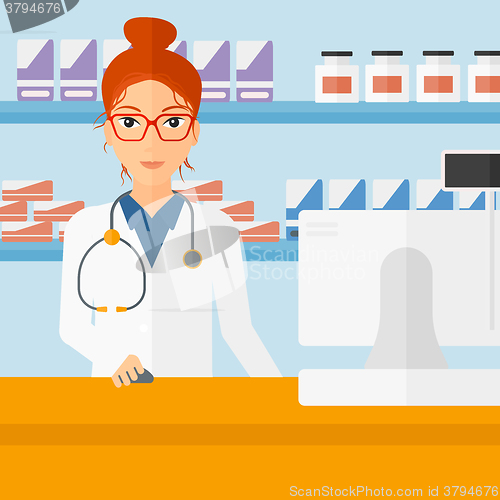 Image of Pharmacist at counter with computer monitor.