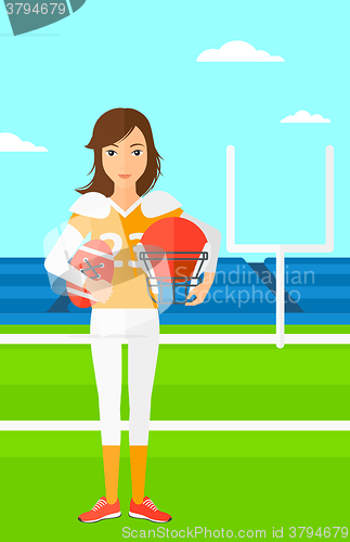 Image of Rugby player with ball and helmet in hands.