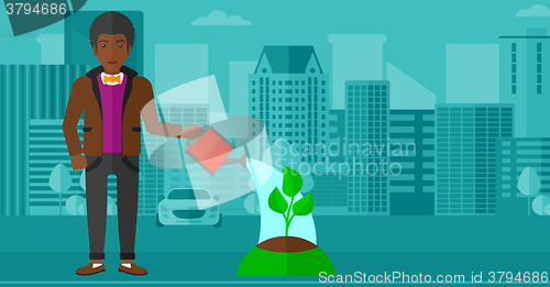 Image of Man watering tree.