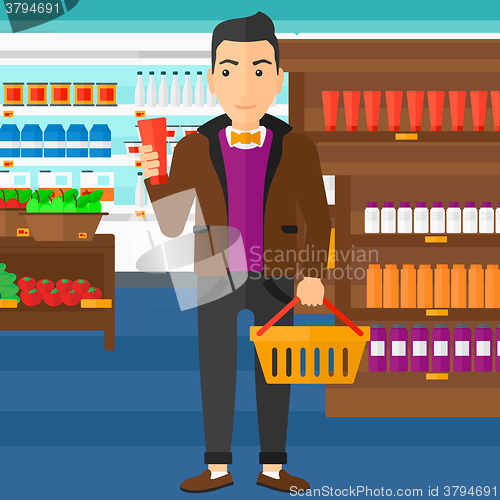 Image of Customer with shopping basket and tube of cream.