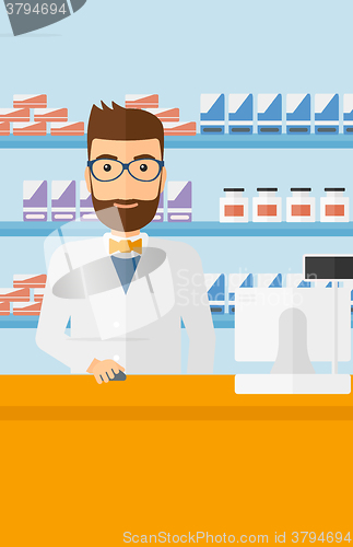 Image of Pharmacist at counter with computer monitor.