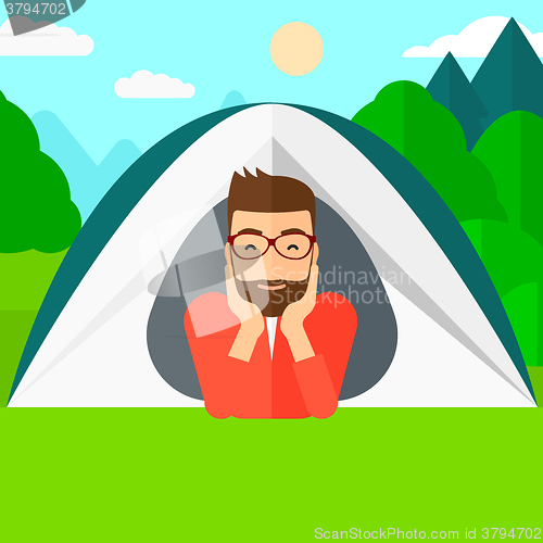 Image of Man lying in tent.