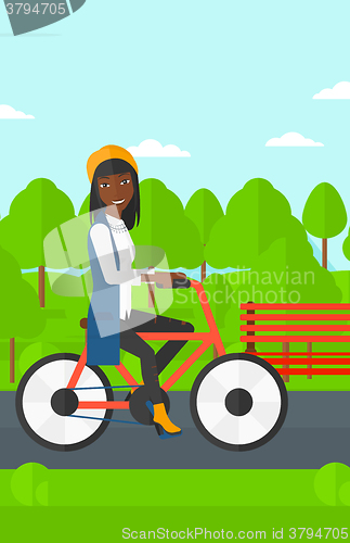 Image of Woman riding bicycle.