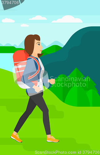 Image of Woman with backpack hiking.