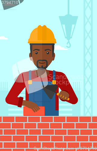 Image of Bricklayer with spatula and brick.